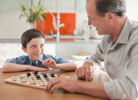man playing checkers with boy